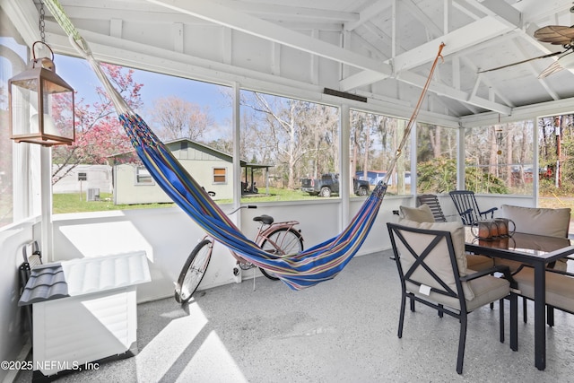 sunroom / solarium featuring vaulted ceiling