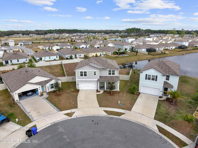 birds eye view of property with a water view and a residential view