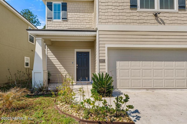 property entrance with a garage and driveway