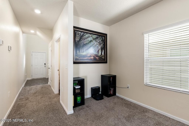 interior space with carpet floors, recessed lighting, and baseboards