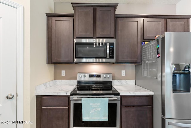 kitchen featuring appliances with stainless steel finishes and dark brown cabinets