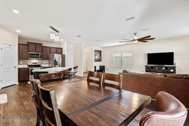 dining space with ceiling fan, visible vents, dark wood-style flooring, and recessed lighting