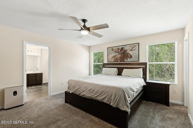 carpeted bedroom with a textured ceiling, ceiling fan, connected bathroom, and baseboards