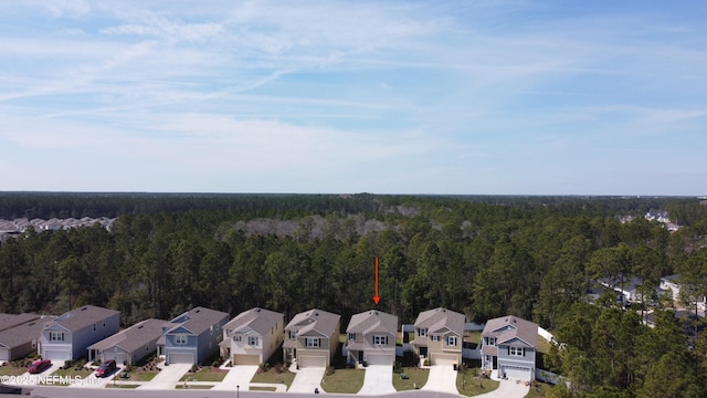 birds eye view of property featuring a residential view and a forest view