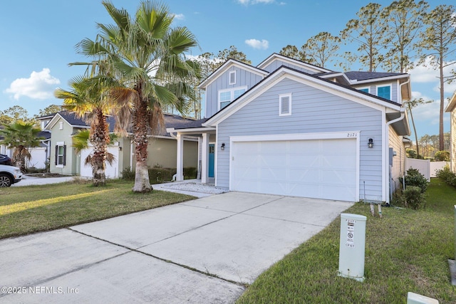 traditional-style home featuring board and batten siding, concrete driveway, a front lawn, and a garage