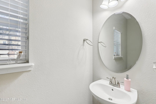 bathroom with a sink and a textured wall