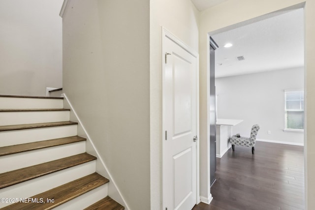 staircase with visible vents, baseboards, wood finished floors, and recessed lighting