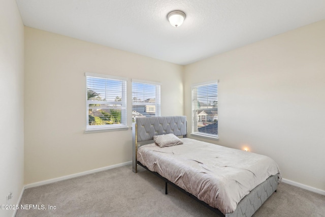 carpeted bedroom featuring baseboards