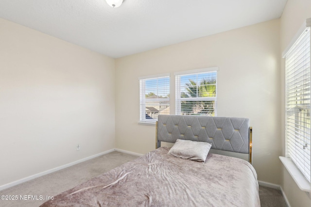 carpeted bedroom with baseboards