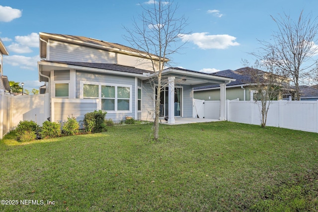 back of house with a patio area, a yard, and a fenced backyard