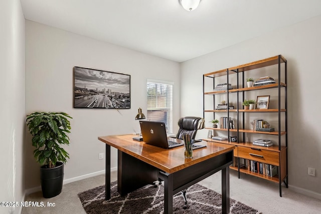 carpeted home office featuring baseboards