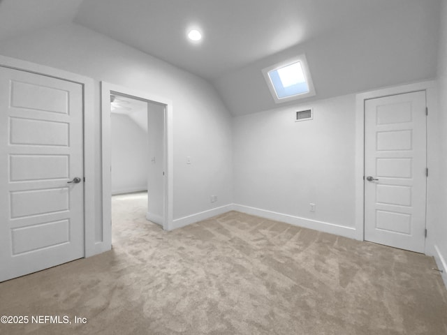 bonus room with lofted ceiling, carpet flooring, visible vents, and baseboards