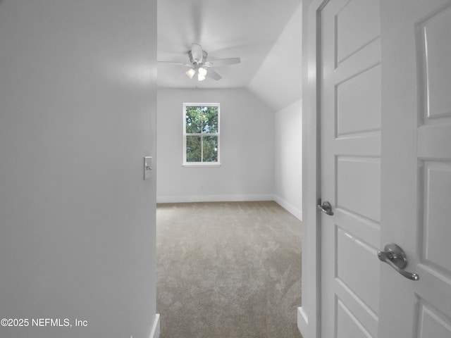 additional living space featuring carpet floors, lofted ceiling, ceiling fan, and baseboards