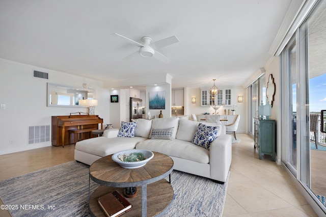 living room featuring ceiling fan with notable chandelier, light tile patterned flooring, and visible vents