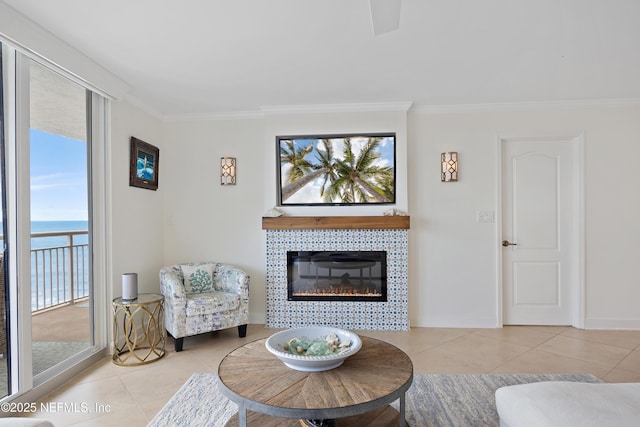 tiled living room with ornamental molding, a fireplace, and baseboards