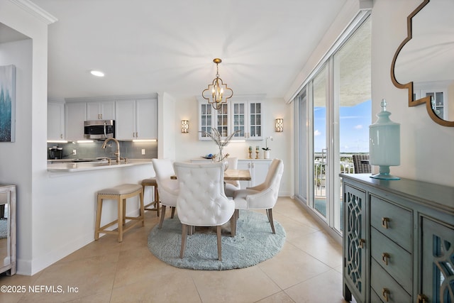 dining space with an inviting chandelier, recessed lighting, baseboards, and light tile patterned flooring