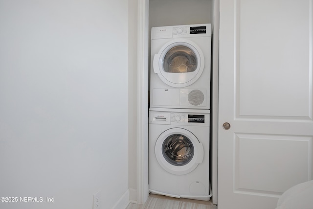 washroom featuring laundry area and stacked washing maching and dryer