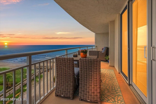 balcony with a water view and a beach view