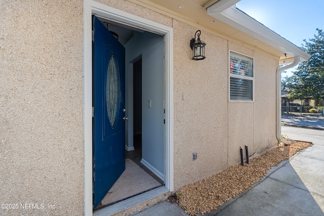 entrance to property with stucco siding