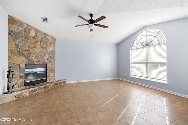 unfurnished living room featuring baseboards, tile patterned flooring, vaulted ceiling, a textured ceiling, and a fireplace