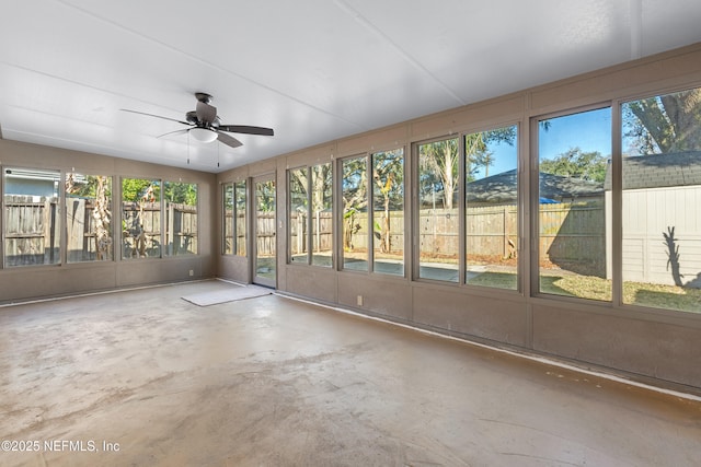 unfurnished sunroom featuring ceiling fan