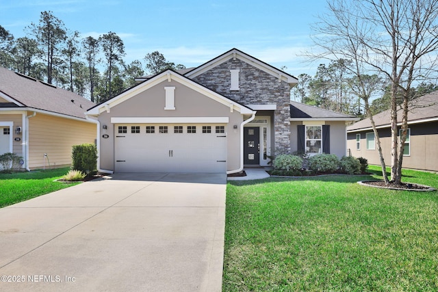 traditional-style home featuring stucco siding, a front yard, a garage, stone siding, and driveway