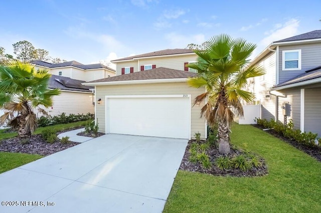 view of front of property with a garage, driveway, and a front yard