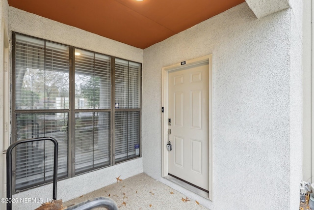 entrance to property with stucco siding