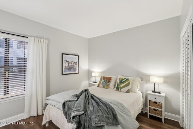 bedroom featuring baseboards and wood finished floors