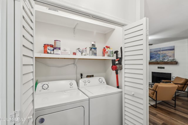 laundry room featuring laundry area, dark wood finished floors, and washing machine and clothes dryer