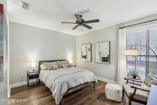 bedroom featuring baseboards, visible vents, ceiling fan, and wood finished floors