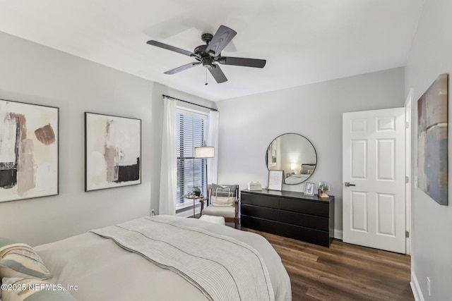 bedroom with ceiling fan, baseboards, and wood finished floors