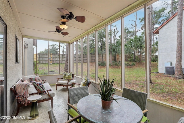 sunroom / solarium featuring ceiling fan