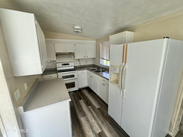 kitchen with white appliances, a sink, white cabinets, backsplash, and dark wood-style floors