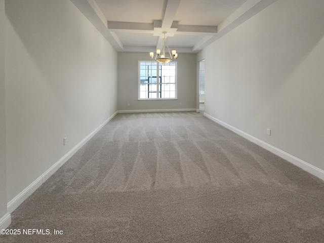 carpeted spare room with coffered ceiling, beamed ceiling, a notable chandelier, and baseboards