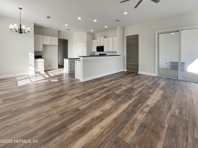 kitchen with dark countertops, black microwave, visible vents, and white cabinets