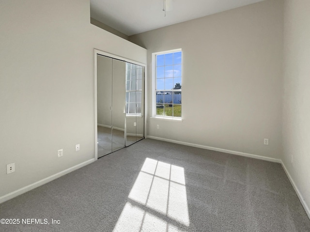 unfurnished bedroom featuring a closet, baseboards, and carpet flooring