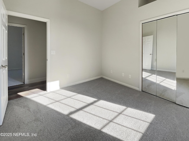 unfurnished bedroom with carpet, baseboards, and a closet