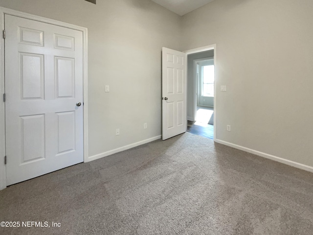 unfurnished bedroom with carpet and baseboards