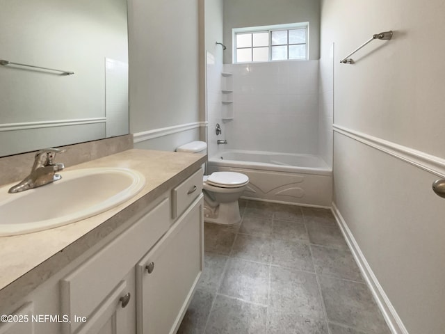 bathroom featuring toilet, shower / bath combination, baseboards, and vanity