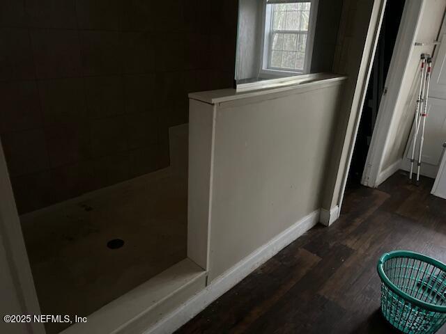 details featuring wood finished floors and baseboards