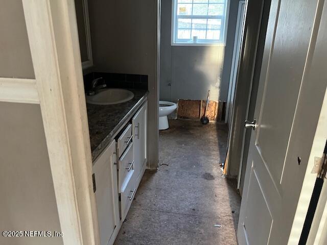 bathroom featuring toilet and vanity