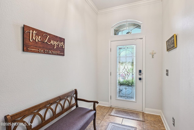 entryway with crown molding and baseboards