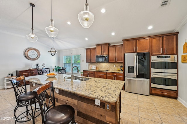 kitchen with visible vents, light tile patterned flooring, a sink, stainless steel appliances, and crown molding