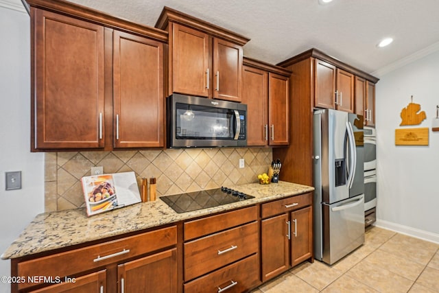 kitchen with backsplash, crown molding, light stone countertops, light tile patterned floors, and stainless steel appliances