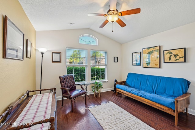 sitting room with hardwood / wood-style floors, lofted ceiling, a textured ceiling, and ceiling fan