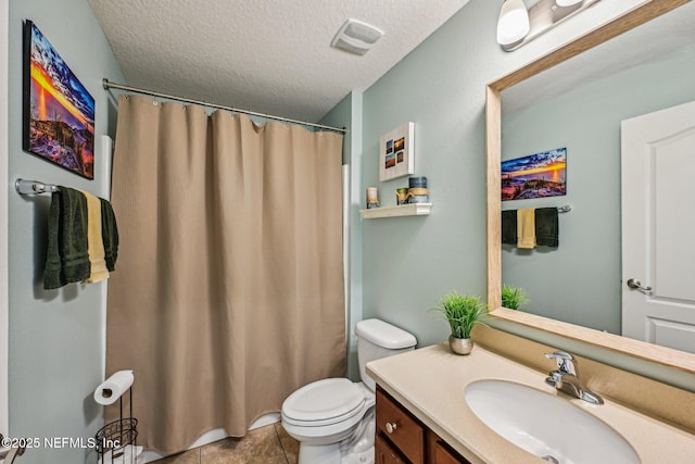 bathroom featuring vanity, visible vents, a textured ceiling, tile patterned floors, and toilet