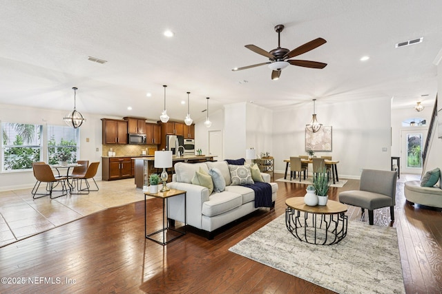 741 W Kings College Dr, Saint Johns, FL 32259 - living area with a ceiling fan, hardwood / wood-style flooring, recessed lighting, a chandelier, and a textured ceiling