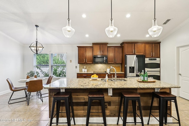 741 W Kings College Dr, Saint Johns, FL 32259 - kitchen with stainless steel appliances, crown molding, light tile patterned floors, backsplash, and a breakfast bar area
