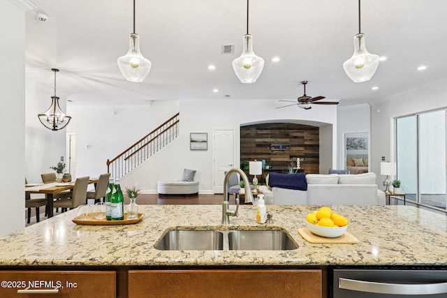 741 W Kings College Dr, Saint Johns, FL 32259 - kitchen with stainless steel dishwasher, open floor plan, ceiling fan, a center island with sink, and ornamental molding